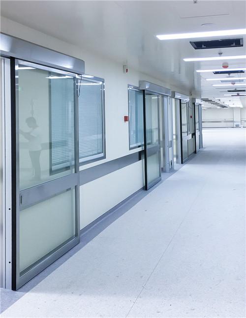 Automatic sliding glass doors in cleanroom corridor with sensor activation